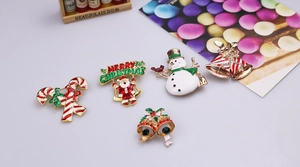 Detail of Christmas brooch set featuring enamel candy cane, snowman, and gold bells