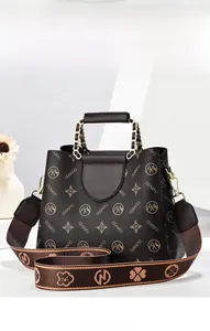 Detail of dark brown leather handbag with textured pattern and decorative chain handle
