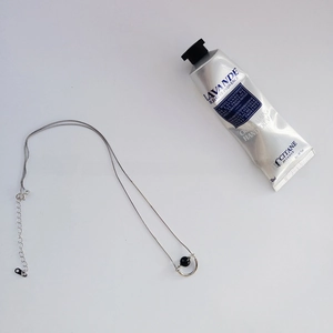 Detail of 925 sterling silver chain necklace with round black agate pendant and extender