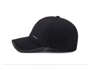 Detail of black plaid winter baseball cap with silver Sport logo and leather brim edging