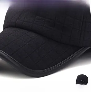 Detail of quilted texture and leather piping on black winter baseball cap for men