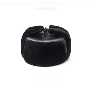 Close-up of black winter trapper hat featuring faux leather finish and soft plush fur lining