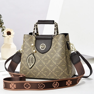 Brown monogram crossbody bag with leather handles and decorative patterned strap