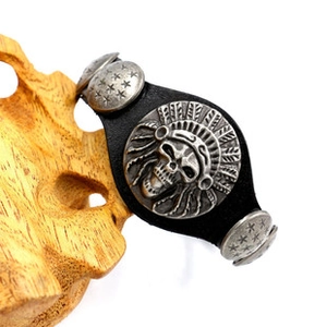 Detail of black leather punk bracelet featuring skull chief and star metal studs