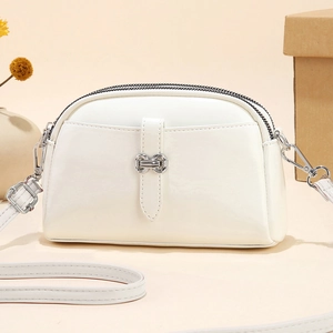 Mini white shell-shaped crossbody bag in soft faux leather with silver decorative buckle