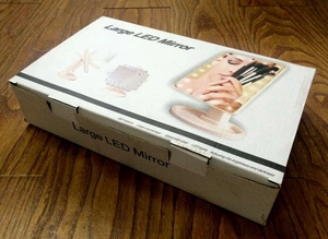 Detail view of large LED makeup mirror packaging showing 360 rotation and bright LED lights