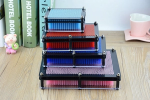Close-up of four colorful 3D pin art toys stacked in pink, blue, and red colors