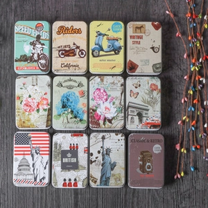 Macro display of twelve vintage tinplate boxes with motorcycle and landmark patterns