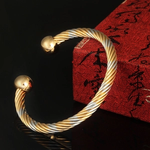 Fashion gold plated two-tone twisted open bangle with round beads on black mirror surface