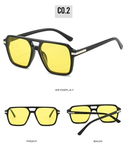 Detailed view of square double bridge sunglasses with yellow lenses and black frames