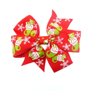 Detail of red grosgrain ribbon bow with festive white snowman and snowflake prints