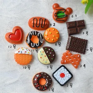 Macro detail of various miniature resin food charms for DIY crafts and phone case decor