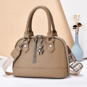 Minimalist khaki brown crossbody bag with wide patterned strap and silver bear charm