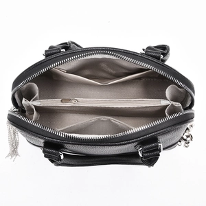 Detailed top view of black leather handbag showing spacious interior and silver charms