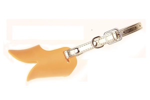 Detailed view of the yellow silicone duckbill muzzle with a durable golden leather strap