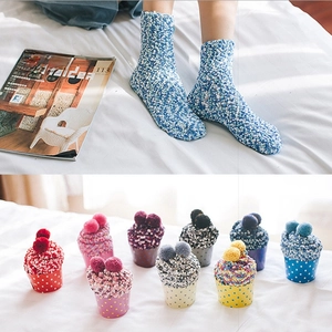 Thick coral fleece thermal socks in colorful cupcake packaging for winter warmth