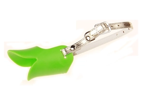 Detail view of green silicone duck-billed dog muzzle with adjustable white leather strap