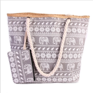 Grey canvas beach tote bag with elephant pattern, woven rope handles and small pouch