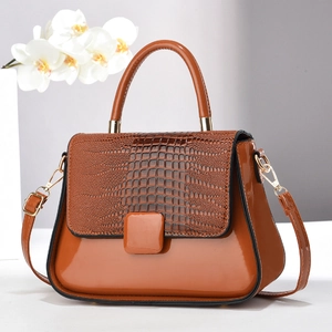 Elegant brown patent leather handbag with crocodile pattern flap and gold hardware