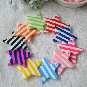 Macro detail of star-shaped striped charms for DIY jewelry and phone case decoration