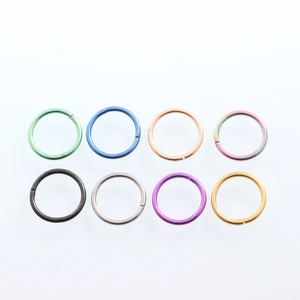 Detailed flat lay of 8 colorful 316 stainless steel seamless hoop earrings for body piercing