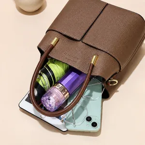Detailed interior of caramel leather crossbody bag showing spacious capacity for daily items