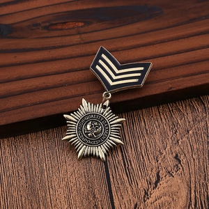 Macro view of vintage bronze eagle badge brooch on dark wood surface showing metallic texture