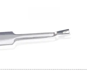 Macro shot of stainless steel V-shaped cuticle trimmer showing the sharp metal blade edge