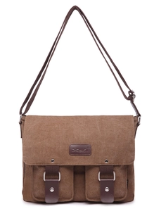 Front detail of vintage brown canvas messenger bag with leather straps and metal buckles