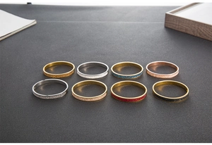Close-up of sparkling crystal-encrusted stainless steel bangles in multiple color sets