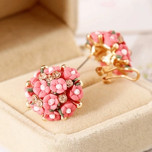 Pink ceramic rose earrings with crystals on beige velvet box, elegant floral design
