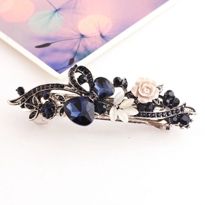 Detail of vintage spring hair clip with blue crystals and white resin rose petals