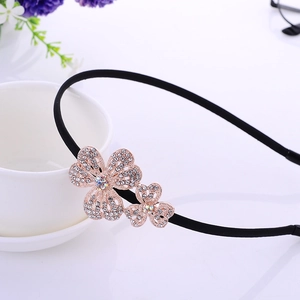Elegant black headband with rose gold rhinestone double flower charms on white background