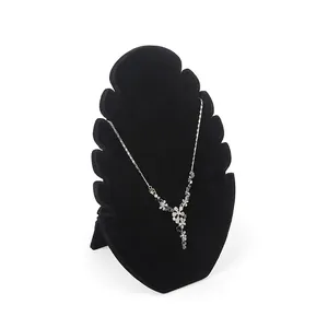 Flame-shaped black velvet jewelry display stand featuring an elegant silver floral necklace