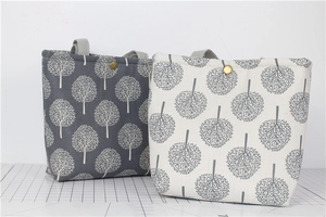 Detail of linen lunch bags with tree patterns and metal button closures in two colors