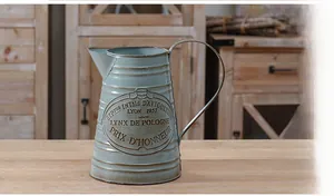 Macro detail of French vintage embossed metal vase with rustic blue finish and aged edges