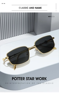 Detail of gold metal frame sunglasses with engraved geometric temples on a grey display
