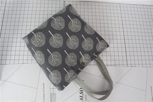 Detail view of cotton linen lunch bag with white tree pattern and golden metal buckle