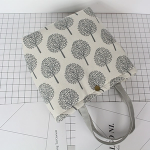 Linen bento bag with gray tree pattern and antique bronze buckle in a 45-degree view