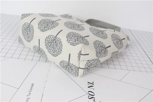 Detail view of cotton linen bento bag with gray tree print and wide bottom structure