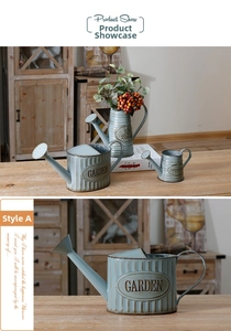 Detail of vintage blue iron garden planters set with embossed GARDEN lettering