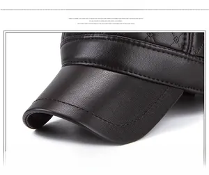 Detailed close-up of brown textured PU leather baseball cap with durable double stitching