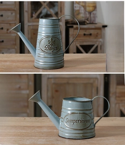 Detail of vintage blue iron watering cans with Potager and Sempervivum metal embossing
