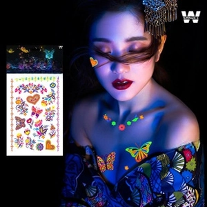 Luminous temporary tattoo stickers with glowing butterflies and flowers on arm