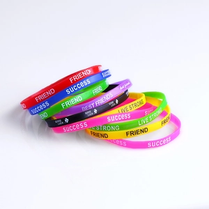 Macro shot of colorful silicone sports wristbands with printed motivational quotes