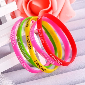 Detailed view of colorful silicone sports wristbands with motivational success quotes