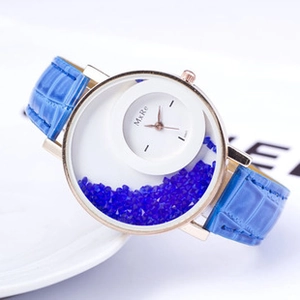 Detail of rose gold quartz watch with blue leather strap and floating blue crystals