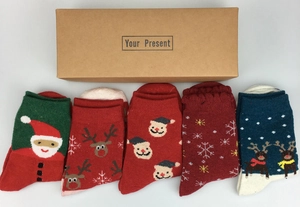 Detailed view of 5 pairs of winter wool Christmas socks with festive deer patterns in gift box