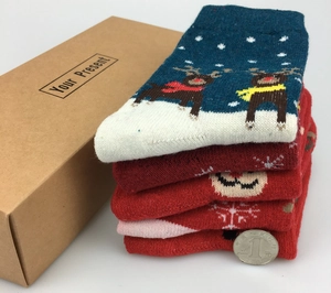 Close-up of thick Christmas wool socks with reindeer patterns in a kraft gift box