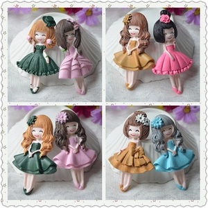 Detail of colorful resin cartoon girl figures for DIY jewelry and hair accessories